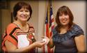 Rebecca Valero of ILWU Local 13 receives her 15-year pin from President Laura Villegas.