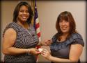 Lynnette Howard, Business Representative for OPEIU Local 537 receives her 15-year pin from President Laura Villegas.